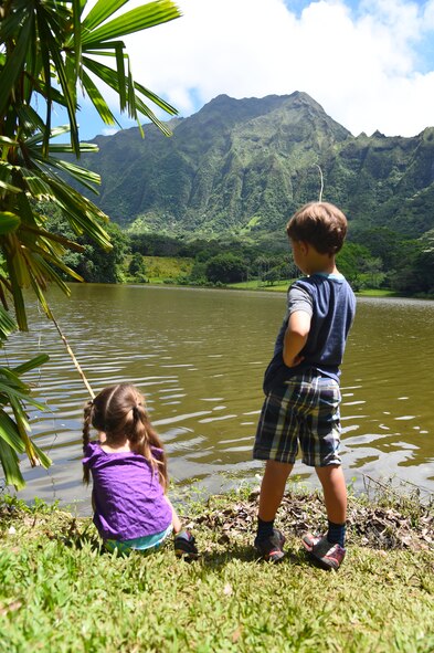 Emelia and Charley Oelrich fish with bamboo fishing poles during the 16th Annual Friends of Hickam Keiki Fishing Tournament  at the Ho`omaluhia Botanical Gardens in Kaneohe, Hawaii, June 5, 2015. The fishing tournament was free for JBPHH Children ages 5-12.(U.S. Air Force photo by Tech. Sgt. Aaron Oelrich/Released)