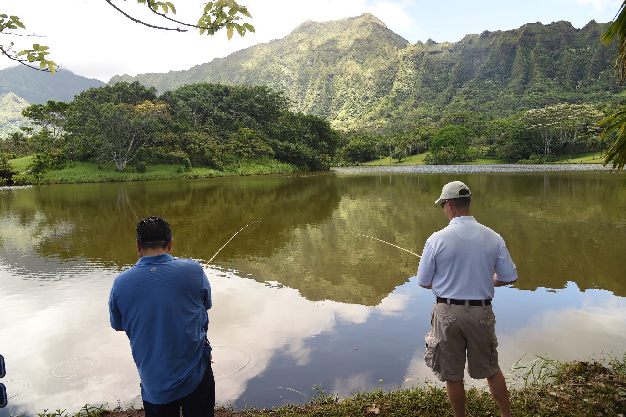 Blane Asao, Friends of Hickam vice president (left) and 15th Wing Commander Col. Randall Huiss compete to catch the first fish to kick off the 16th Annual Friends of Hickam Keiki Fishing Tournament at the Ho`omaluhia Botanical Gardens, Kaneohe,  June 5, 2015. More than 100 members of Joint Base Pearl Harbor-Hickam and their children participated in the free fishing tournament hosted by "Friends of Hickam," an organization seeking to support, promote, and foster strong community relations with military families. (U.S. Air Force photo by Tech. Sgt. Aaron Oelrich/Released) 