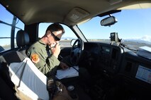 Lt. Col. James Sage ,199th Fighter Squadron commander, talks to maintenance Airmen to coordinate F-22 Raptors ground refueling on  Joint Base Pearl Harbor-Hickam, Hawaii, June 6, 2015. Pilots of the F-22 from the Hawaii Air National Guard’s 199th Fighter Squadron and the 19th Fighter Squadron teamed up with maintenance Airmen from the 154th Wing and 15th Maintenance Group to launch and recover 62 Raptors in a day. (U.S. Air Force photo by Tech. Sgt. Aaron Oelrich/Released)   