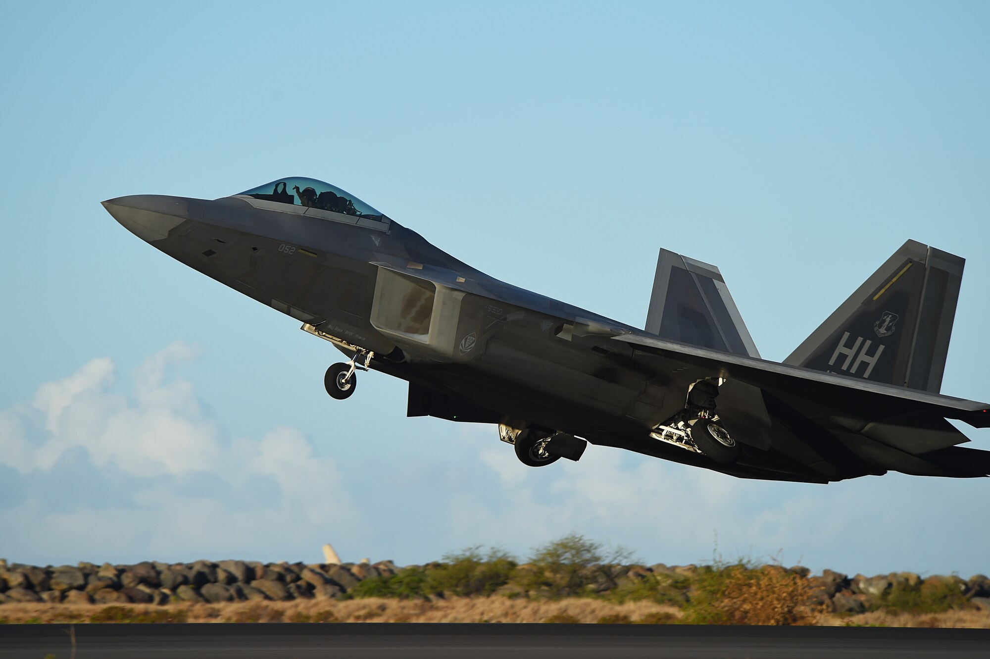 A F-22 Raptor, from the 199th Fighter Squadron, increases altitude shortly after taking off from Joint Base Pearl Harbor-Hickam, Hawaii, June 6, 2015. F-22 Pilots from the Hawaii Air National Guard’s 199th Fighter Squadron and the 19th Fighter Squadron teamed up with maintenance Airmen from the 154th Wing and 15th Maintenance Group to launch and recover 62 Raptors in a day. The previous record was 46 sorties in one day with 14 aircraft, this recorded was broken using only 12 of the 18 aircraft in the smallest F-22 squadron in the Air Force. (U.S. Air Force photo by Tech. Sgt. Aaron Oelrich/Released)   