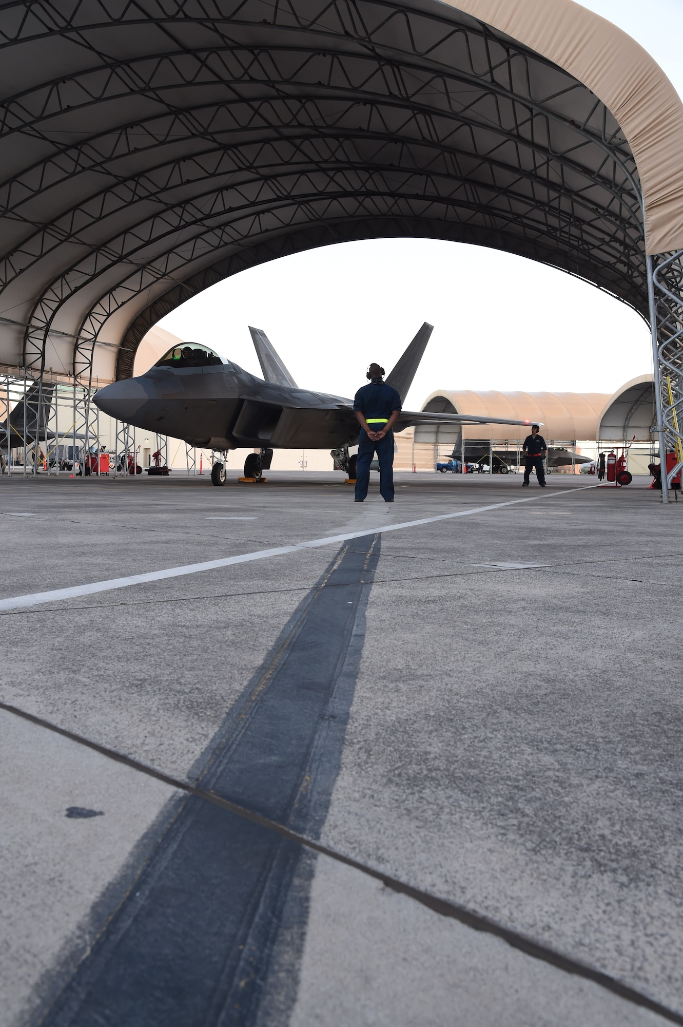 Airmen from the 154th Maintenance Squadron prepare to launch a F-22 Raptor from the 199th Fighter Squadron on Joint Base Pearl Harbor-Hickam, Hawaii, June 6, 2015. F-22 Pilots from the Hawaii Air National Guard’s 199th Fighter Squadron and the 19th Fighter Squadron teamed up with maintenance Airmen from the 154th Wing and 15th Maintenance Group to launch and recover a record 62 Raptors in a day. (U.S. Air Force photo by Tech. Sgt. Aaron Oelrich/Released)  