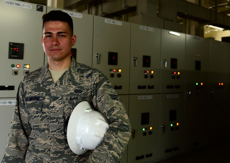 U.S. Air Force Senior Airman Andres Diaz Medina, 35th Civil Engineer Squadron electrical systems technician, poses at an electrical substation at Misawa Air Base, Japan, June 8, 2015. Diaz Medina maintains and supports Misawa’s electrical network to ensure its serviceability to the base. (U.S. Air Force photo by Airman 1st Class Jordyn Fetter/Released)