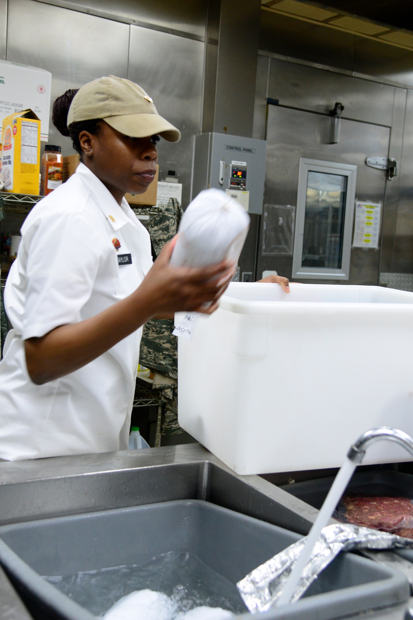 Army Specialist Giovonni Taylor, NCO in charge of 35th Air Defense Artillery Brigade food service, thaws out meat April 2, 2015, at Osan Air Base, Republic of Korea. Food service specialists prepare food items for each meal two hours before hand. (U.S. Air Force photo by Senior Airman Matthew Lancaster)