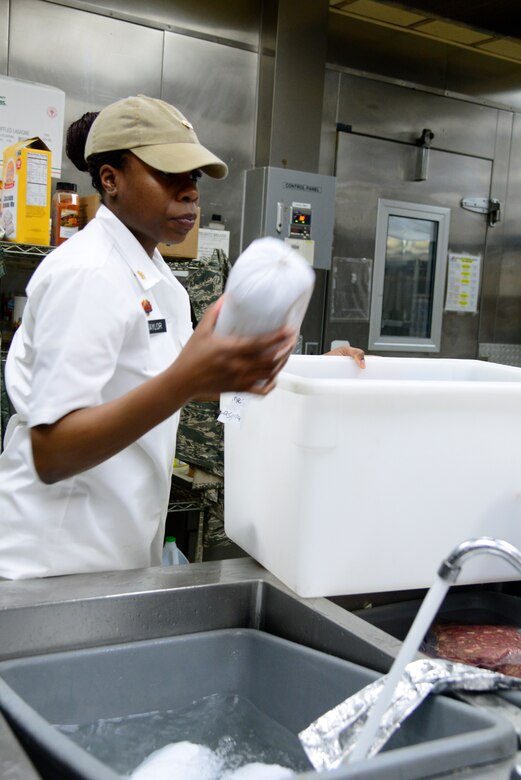 Army Specialist Giovonni Taylor, NCO in charge of 35th Air Defense Artillery Brigade food service, thaws out meat April 2, 2015, at Osan Air Base, Republic of Korea. Food service specialists prepare food items for each meal two hours before hand. (U.S. Air Force photo by Senior Airman Matthew Lancaster)