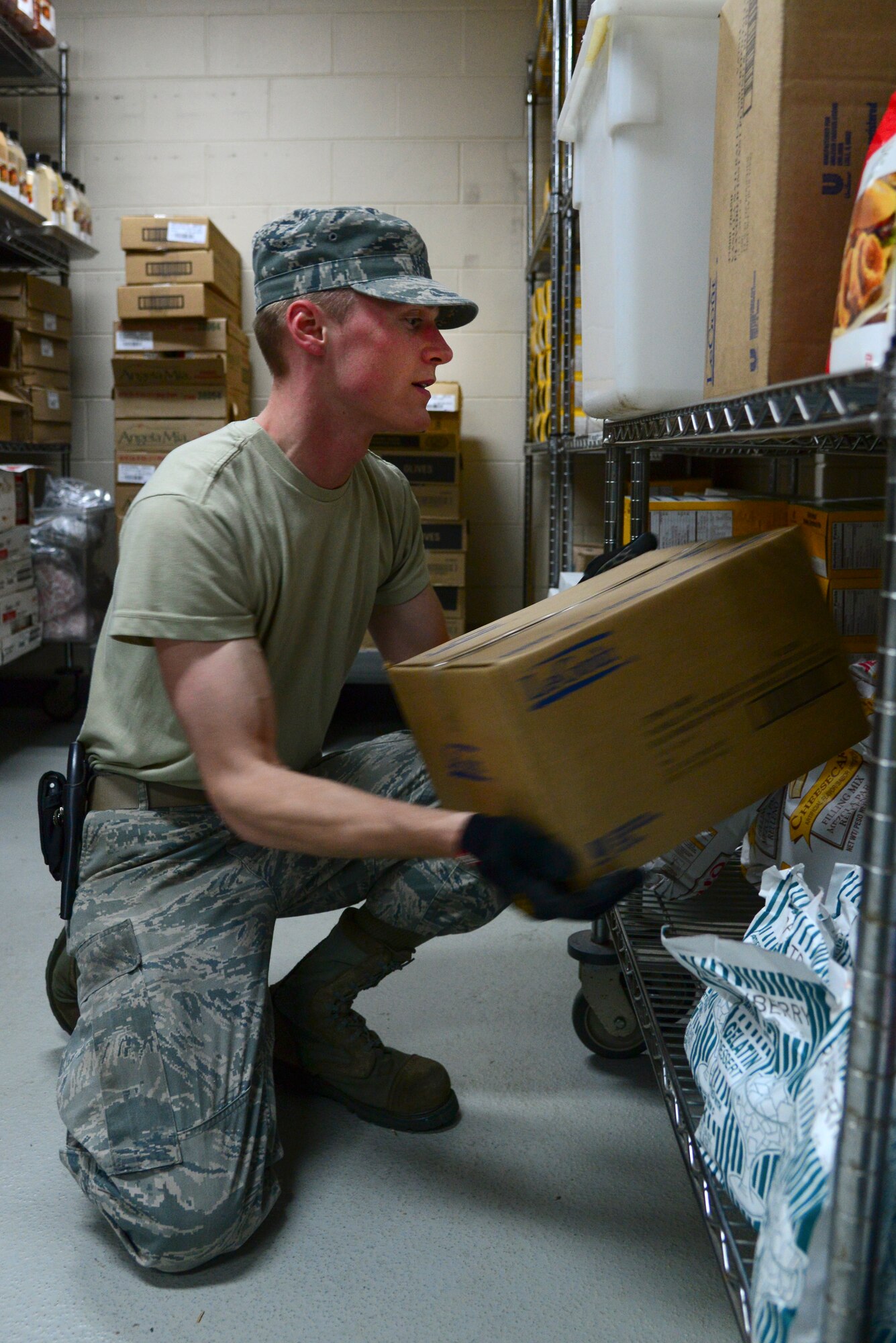 Airman 1st Class Jonathan Pippe, 51st Force Support Squadron food service specialist, stocks Ginko Tree food items onto shelves in the store room April 1, 2015, at Osan Air Base, Republic of Korea. Working the store room means being responsible for thousands of dollars' worth of food every month that must be stored, inventoried and accounted for with every delivery. (U.S. Air Force photo by Senior Airman Matthew Lancaster)