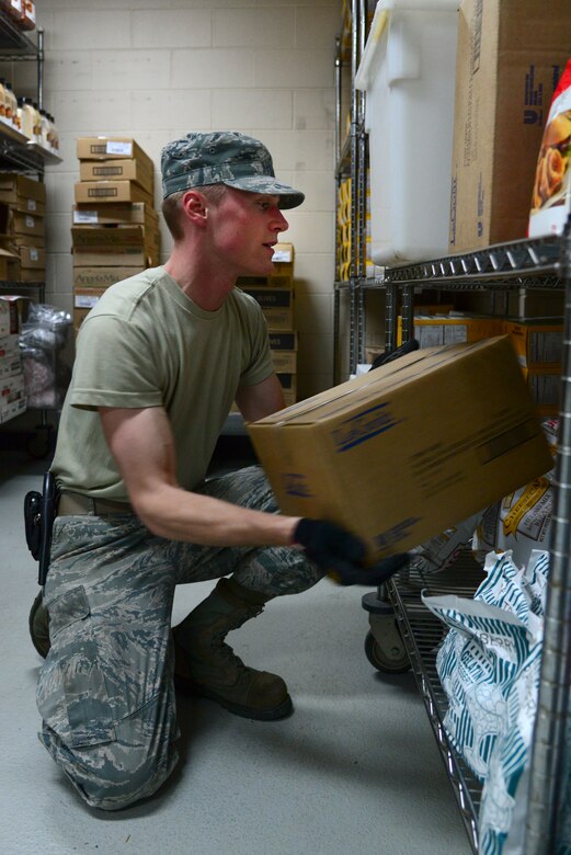 Airman 1st Class Jonathan Pippe, 51st Force Support Squadron food service specialist, stocks Ginko Tree food items onto shelves in the store room April 1, 2015, at Osan Air Base, Republic of Korea. Working the store room means being responsible for thousands of dollars' worth of food every month that must be stored, inventoried and accounted for with every delivery. (U.S. Air Force photo by Senior Airman Matthew Lancaster)