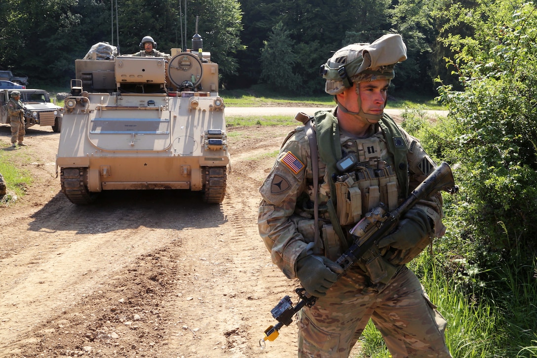 U.S Army Cpt. Matthew Grove ground guides an M1068A3 Standard Integrated Command Post System Carrier during a tactical movement exercise, part of Combined Resolve IV at the U.S. Army’s Joint Multinational Readiness Center in Hohenfels, Germany, May 28, 2015. Grove is assigned to the 3rd Infantry Division's Headquarters Company, 3rd Combined Arms Battalion, 69th Armor Regiment, 1st Armored Brigade Combat Team.