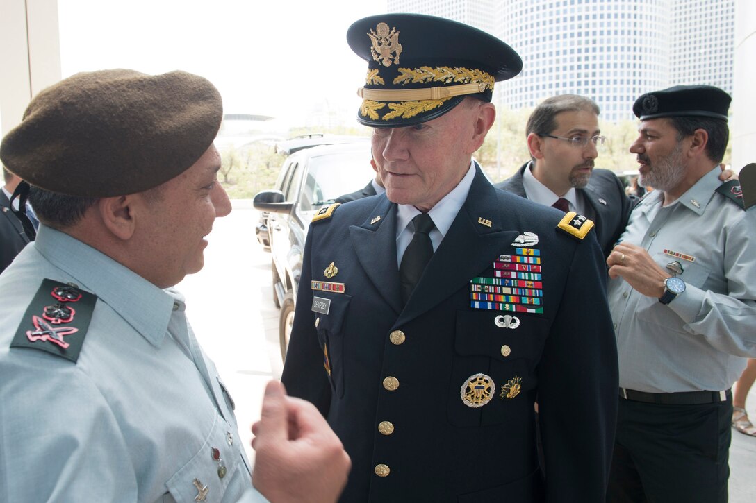 U.S. Army Gen. Martin E. Dempsey, chairman of the Joint Chiefs of Staff, talks with Israeli Defense Chief Lt. Gen. Gadi Eisenkot while U.S. Ambassador to Israel Daniel B. Shapiro, back left, talks with Maj. Gen. Yaacov Ayish, defense attaché to the United States, before they participate in a honor guard ceremony in Tel Aviv, Israel, June 9, 2015.  