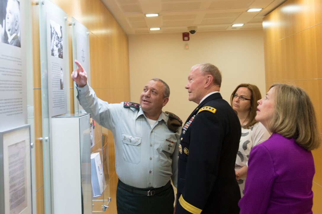 Israeli Defense Chief Lt. Gen. Gadi Eisenkot, left, shows displays to U.S. Army Gen. Martin E. Dempsey, chairman of the Joint Chiefs of Staff, outside his office in Tel Aviv, Israel, June 9, 2015.  