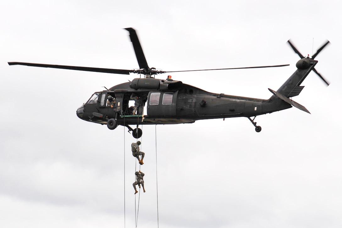 U.S. troops rappel from a UH-60 Black Hawk helicopter during an air assault course at the 7th Army Joint Multinational Training Command's Grafenwoehr Training Area, Germany, June 9, 2015.