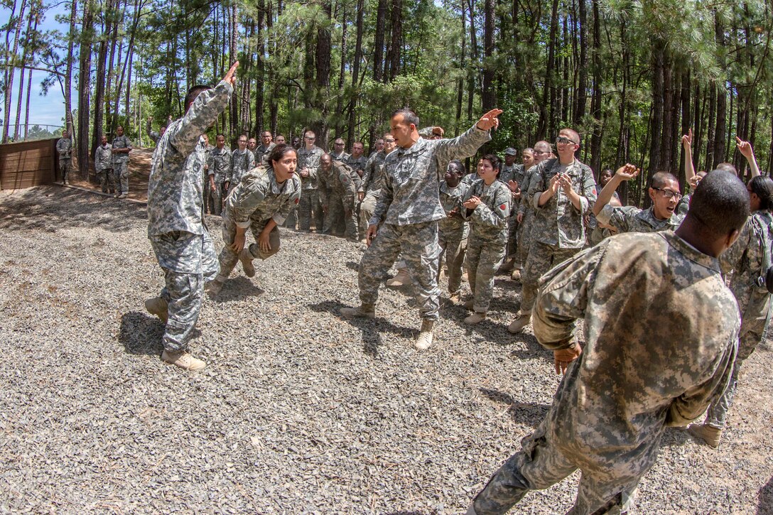 A soldier races to the finish line as her platoon cheers her on at the endurance obstacle course during the second week of basic combat training at Fort Jackson, S.C., May 29, 2015.