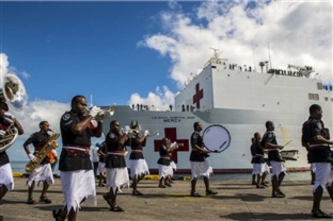 The Fiji Police Band welcomes the Military Sealift Command hospital ship USNS Mercy to Suva, Fiji, with a musical performance, June 7, 2015. Fiji is the Mercy’s first mission port for Pacific Partnership 2015.