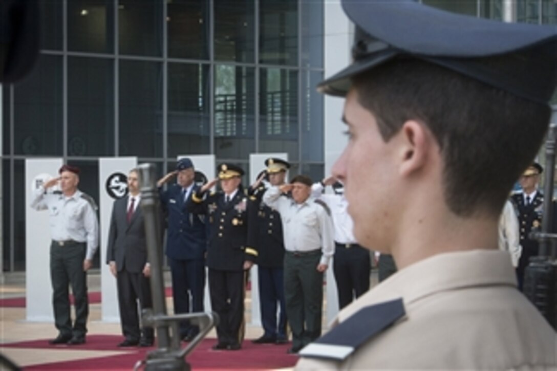 U.S. Army Gen. Martin E. Dempsey, fourth from left, chairman of the Joint Chiefs of Staff, salutes for the playing of the U.S. and Israeli national anthems during his official arrival ceremony in Tel Aviv, Israel, June 9, 2015.