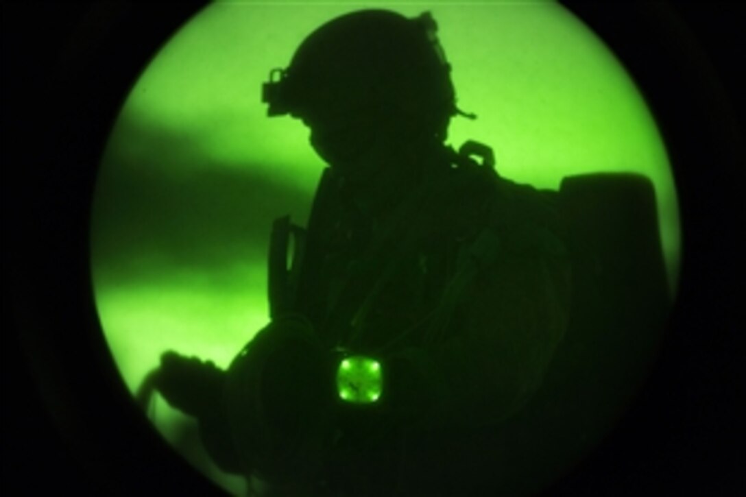 As seen through a night-vision device, a Marine recovers his parachute after conducting a high-altitude, high-opening jump during sustainment training in Louisburg, N.C., June 5, 2015. The training allowed the Marines to practice proper techniques and procedures while preparing for deployment to the 5th and 6th Fleet areas of responsibility later this year. The Marine is assigned to the Maritime Raid Force, 26th Marine Expeditionary Unit.