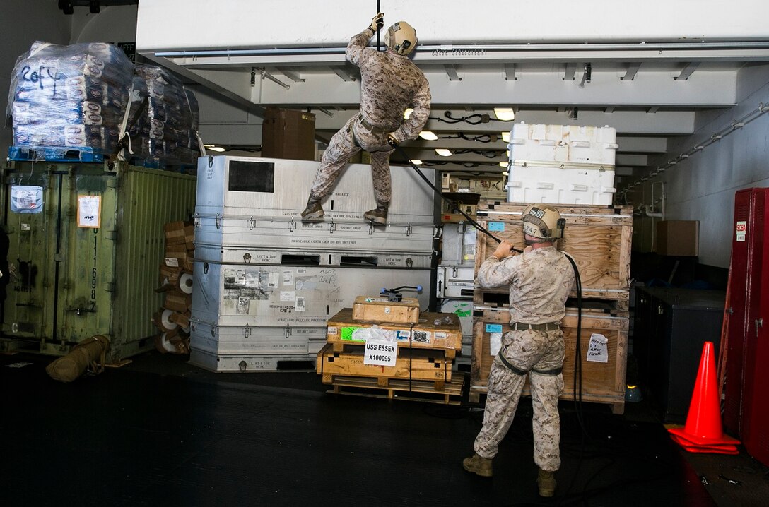 U.S. Marines with the 15th Marine Expeditionary Unit’s Maritime Raid Force rappel in the hangar bay of the USS Essex (LHD 20 in the East China Sea, June 2, 2015. The Marines also went over lowering procedures so, if necessary, they would be able to lower a casualty from mountainous terrain or a gas-oil platforms during operations. (U.S. Marine Corps photo by Cpl. Anna Albrecht/Released)