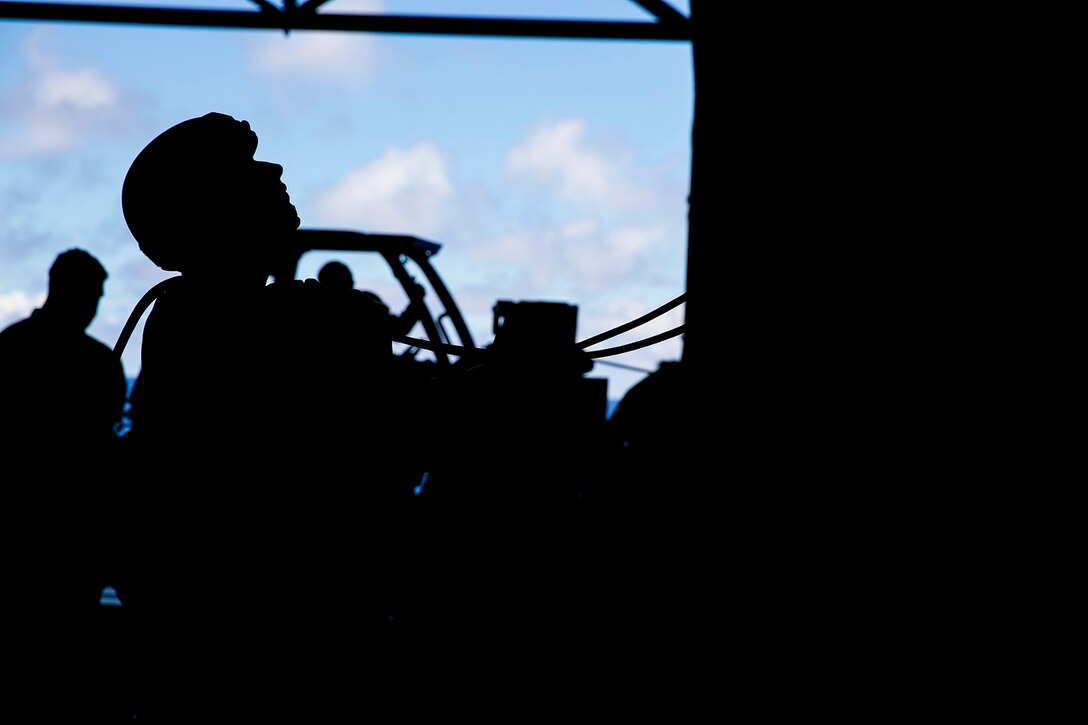 A U.S. Marine with the 15th Marine Expeditionary Unit’s Maritime Raid Force belays a fellow Marine in the hangar bay of the USS Essex (LHD 2) in the East China Sea, June 2, 2015. The Marines also went over lowering procedures so, if necessary, they would be able to lower a casualty from mountainous terrain or a gas-oil platforms during operations. (U.S. Marine Corps photo by Cpl. Anna Albrecht/Released)
