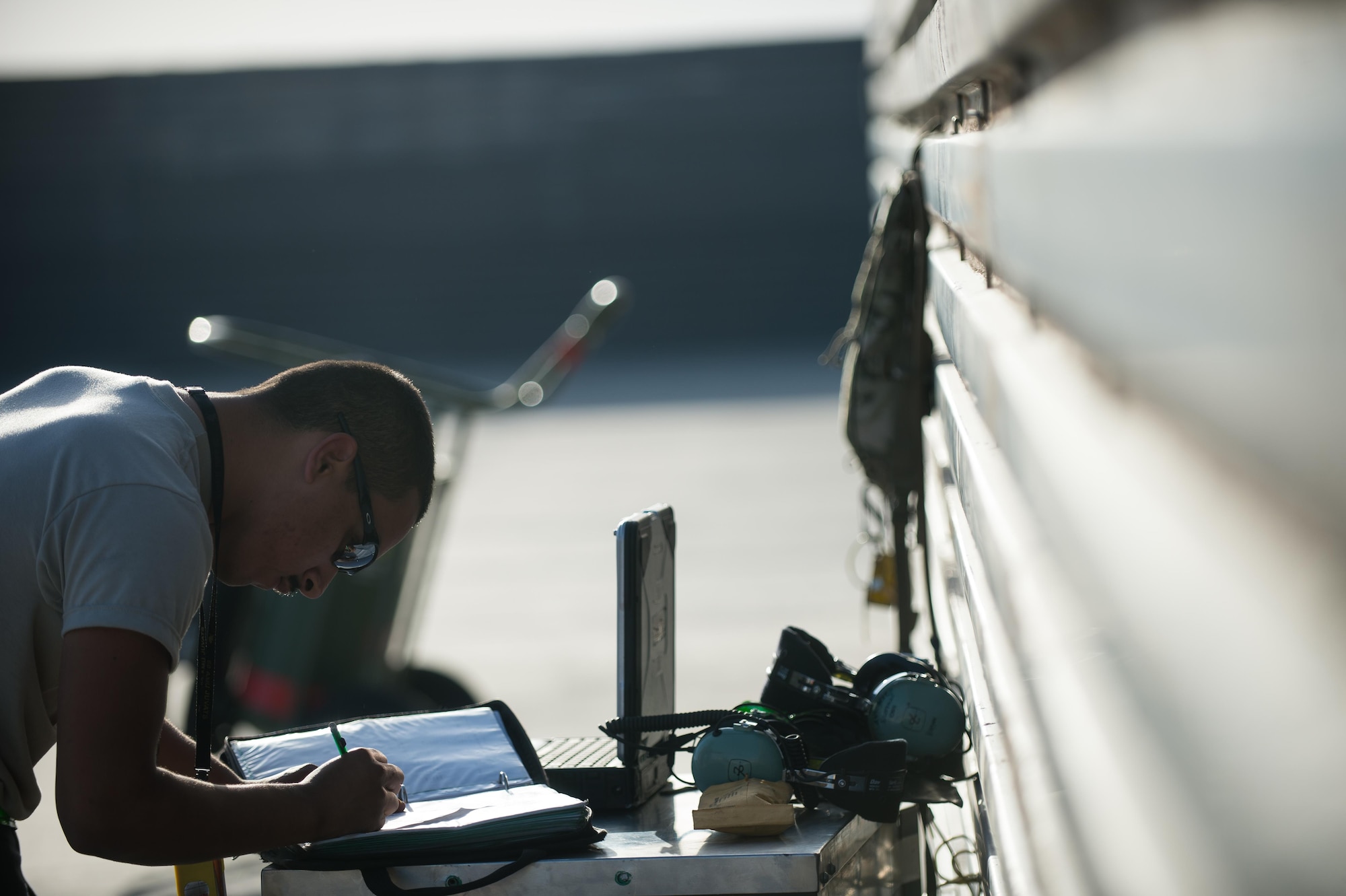 U.S. Air Force Senior Airman Joseph Santana, 455th Expeditionary Aircraft Maintenance Squadron crew chief, completes paperwork before an F-16 Fighting Falcon aircraft post flight inspection at Bagram Airfield, Afghanistan, June 8, 2015. The 455th EAMXS ensure Fighting Falcons on Bagram are prepared for flight and return them to a mission-ready state once they land.  (U.S. Air Force photo by Tech. Sgt. Joseph Swafford/Released)