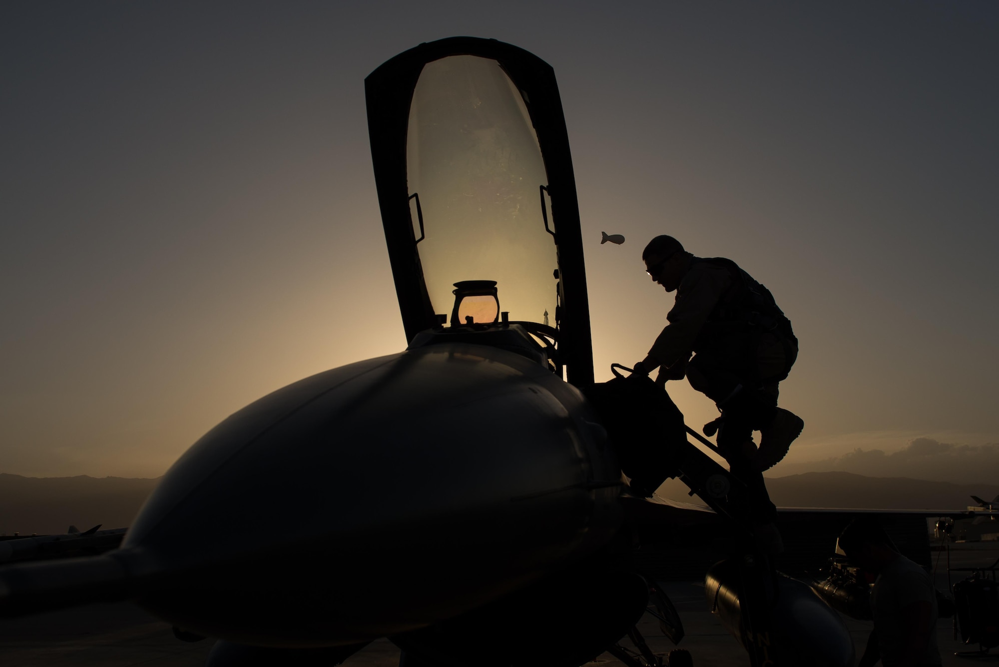 U.S. Air Force Capt. Doug Mayo, 555th Expeditionary Fighter Squadron, enters an F-16 Fighting Falcon aircraft before conducting a preflight inspection with Staff Sgt. William Harris, 455th Expeditionary Maintenance Squadron crew chief, at Bagram Airfield, Afghanistan, June 8, 2015. The 455th EAMXS ensure Fighting Falcons on Bagram are prepared for flight and return them to a mission-ready state once they land.  (U.S. Air Force photo by Tech. Sgt. Joseph Swafford/Released)