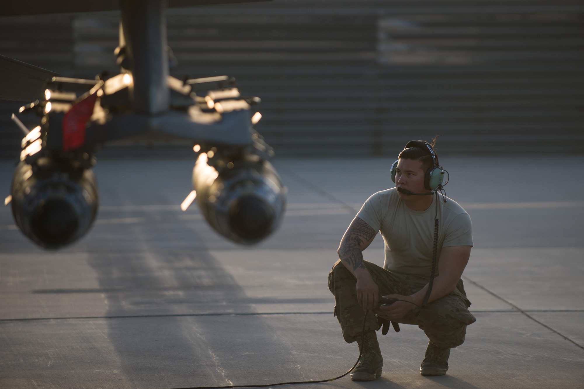 U.S. Air Force Staff Sgt. William Harris, 455th Expeditionary Maintenance Squadron crew chief, looks on during an F-16 Fighting Falcon aircraft preflight inspection at Bagram Airfield, Afghanistan, June 8, 2015. The 455th EAMXS ensure Fighting Falcons on Bagram are prepared for flight and return them to a mission-ready state once they land.  (U.S. Air Force photo by Tech. Sgt. Joseph Swafford/Released)