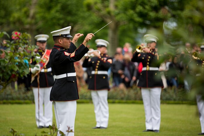 U.S. Marine Corps GySgt. Tracy Martinez, a Enlisted Conductor with the 1st Marine Division Band, conducts the band during an anniversary ceremony with the French Legionnaires on Aisne Marne American Cemetery in Belleau, France, on May 31, 2015. The ceremony was held to commemorate the Battle of Belleau Wood. (U.S. Marine Corps Photo by Sgt. Luis A. Vega/Released)