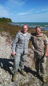 U.S. Air Force Master Sgt. Thomas Frutos and Latvian Maj. Vilnis Metlans pose for a picture near Lake Huron in Rogers City, Mich., in during a break from Operation Northern Strike in August 2014.Frutos and Metlans worked together in Michigan and overseas and their work contributed to Frutos’ award of the Latvian National Armed Forces Air Force Commander Award of Honor, Grade 3, in Lielvarde, Latvia, April 30, 2015. Frutos is assigned to the 217th Air Operations Group, Michigan Air National Guard, based at Battle Creek, Mich., and is the first U.S. Armed Forces member to receive the Latvian award. He was recognized for his expertise in airspace management, which resulted in a letter of agreement between the Latvian Civil Aviation Authority and the Latvian military creating military training airspace. (U.S. Air Force photo/Released)