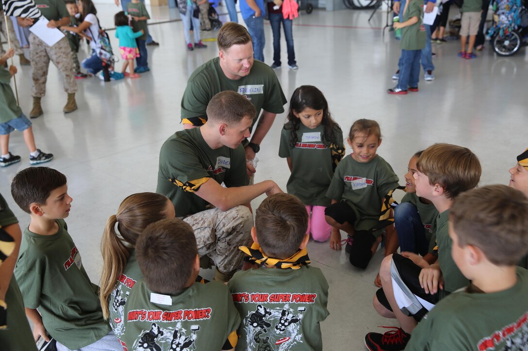 Children of service members with Marine Aircraft Group (MAG) 16 participate in a briefing at Marine Aircraft Group 16's Junior Jarhead Day aboard Marine Corps Air Station Miramar, Calif., June 6. The children were split into four different platoons with volunteer Marine leaders. (U.S. Marine Corps photo by Lance Cpl. Kimberlyn D. Adams/Released)