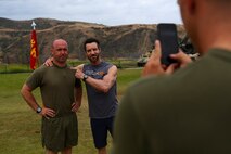 Sergeant Jeran Black, a squad leader assigned to India Co., 3rd Battalion, 5th Marine Regiment, poses for a photo with the creator of P90X, Tony Horton aboard Camp Pendleton, Calif., June 9, 2015. Horton visited the Marines and spent the morning conducting physical training and answering questions the Marines had.