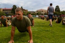 Corporal Justin Carpenter, a squad leader with 3rd Battalion, 5th Marine Regiment, conducts exercises with Tony Horton, the creator of the fitness program, P90X aboard Camp Pendleton, Calif., June 9, 2015. Horton believes Marines need to focus on nutrition and a wide variety of exercises to be ready for any mission as may be directed.