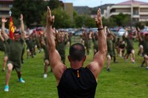 Juan Urquiaga, a trainer with Tony Horton, the creator of the fitness program P90X, demonstrates an exercise for Marines assigned to 3rd Battalion, 5th Marine Regiment, aboard Camp Pendleton, Calif., June 9, 2015. Horton believes Marines need to focus on nutrition and a wide variety of exercises to be ready for any mission as may be directed.