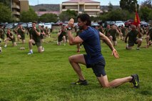 Bobby Stevenson, a trainer with Tony Horton, the creator of the fitness program P90X, demonstrates an exercise for Marines assigned to 3rd Battalion, 5th Marine Regiment, aboard Camp Pendleton, Calif., June 9, 2015. Horton believes Marines need to focus on nutrition and a wide variety of exercises to be ready for any mission as may be directed.