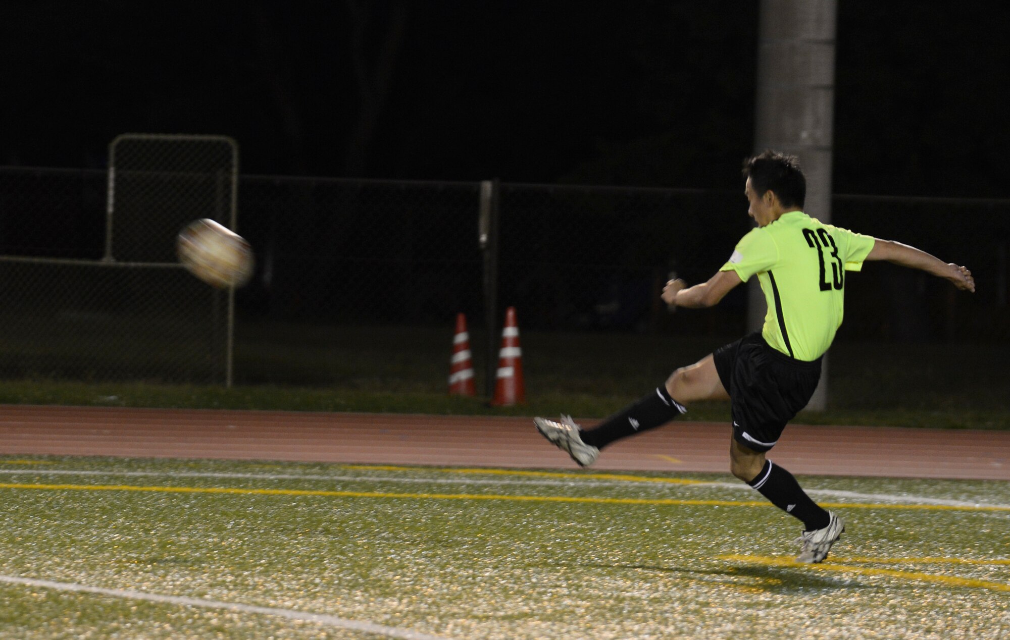 Tachi Saguira, FUSSA Football Club player, passes the ball to a teammate during the second half of a soccer game against the Musketeers Football Club June 7, 2015, at Yokota Air Base, Japan. The game was tied 1-1 at half time, with the FUSSA FC going on to lose 4-2. (U.S. Air Force photo by Senior Airman David Owsianka/Released)