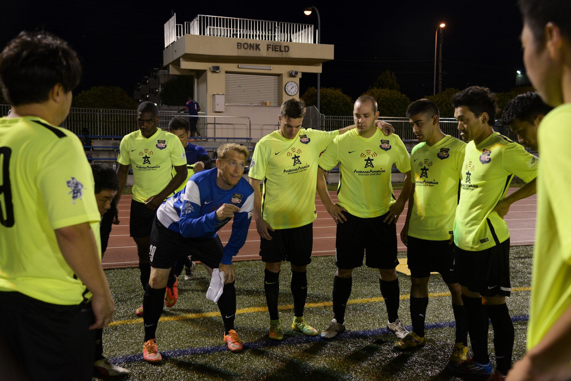 Trent Anderson, FUSSA Football Club coach, talks to the FUSSA FC team during half time of a soccer game against the Musketeers Football Club June 7, 2015, at Yokota Air Base, Japan. The Fussa FC has a 12-3-2 record. (U.S. Air Force photo by Senior Airman David Owsianka/Released)