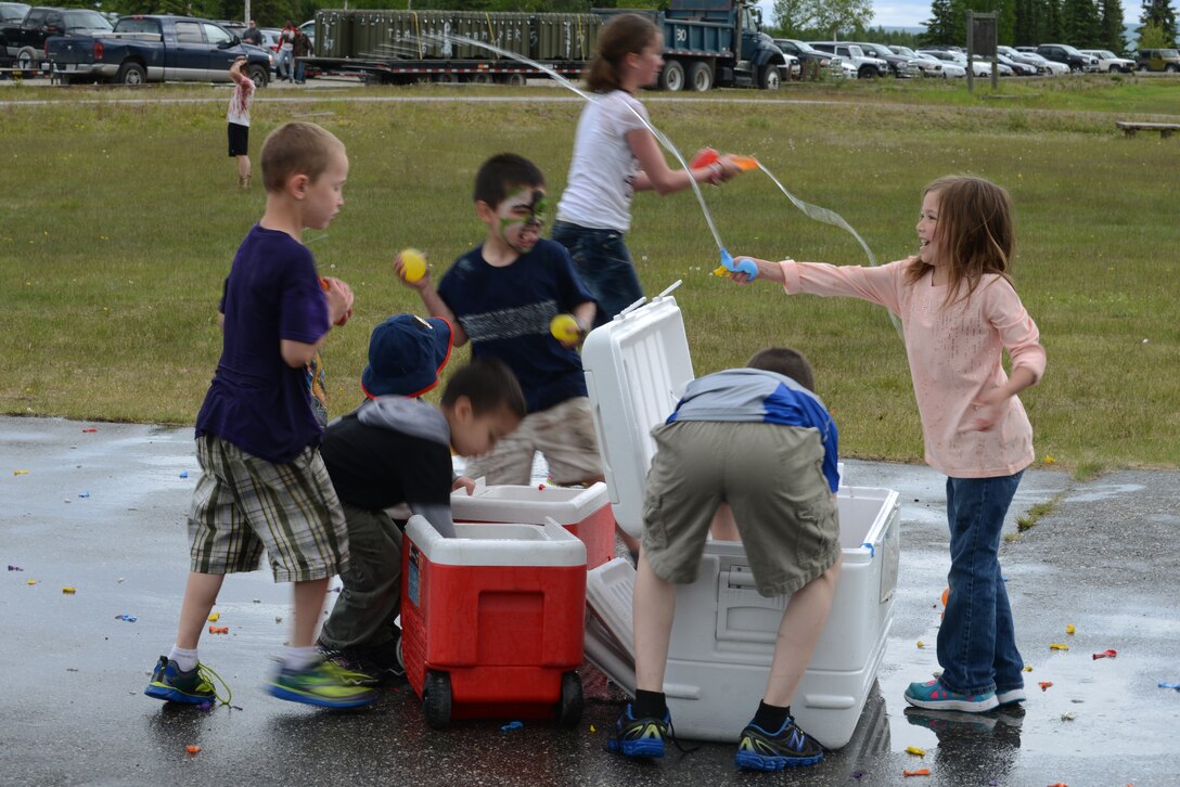 Children engage in a water balloon fight during the 354th Mission Support Group (MSG) Summer Bash June 5, 2015, at the Chena Lake Recreation Area in North Pole, Alaska. The water balloon fight was one of many activities held for children of MSG family members. (U.S. Air Force photo by Senior Airman Ashley Nicole Taylor/Released)