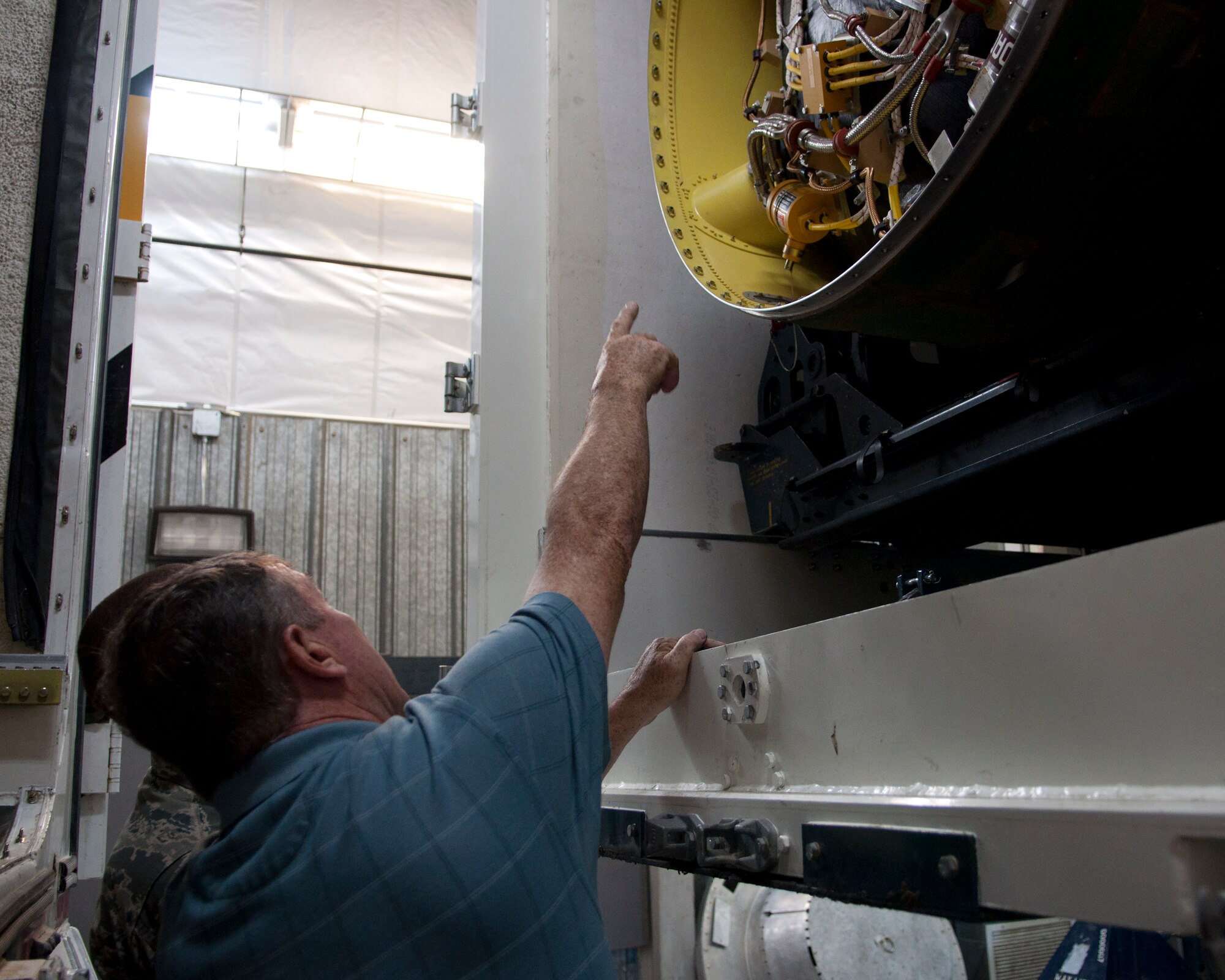 Richard Mullee, 90th MW Safety Office missile safety superintendent, examines the mid-section of the booster of the Minuteman III ICBM during the 90th Missile Maintenance Squadron’s annual weapons safety inspection June 9, 2015, on F.E. Warren Air Force Base, Wyo. This was the last part of the teams inspection of the squadron. (U.S. Air Force photo by Airman 1st Class Malcolm Mayfield)