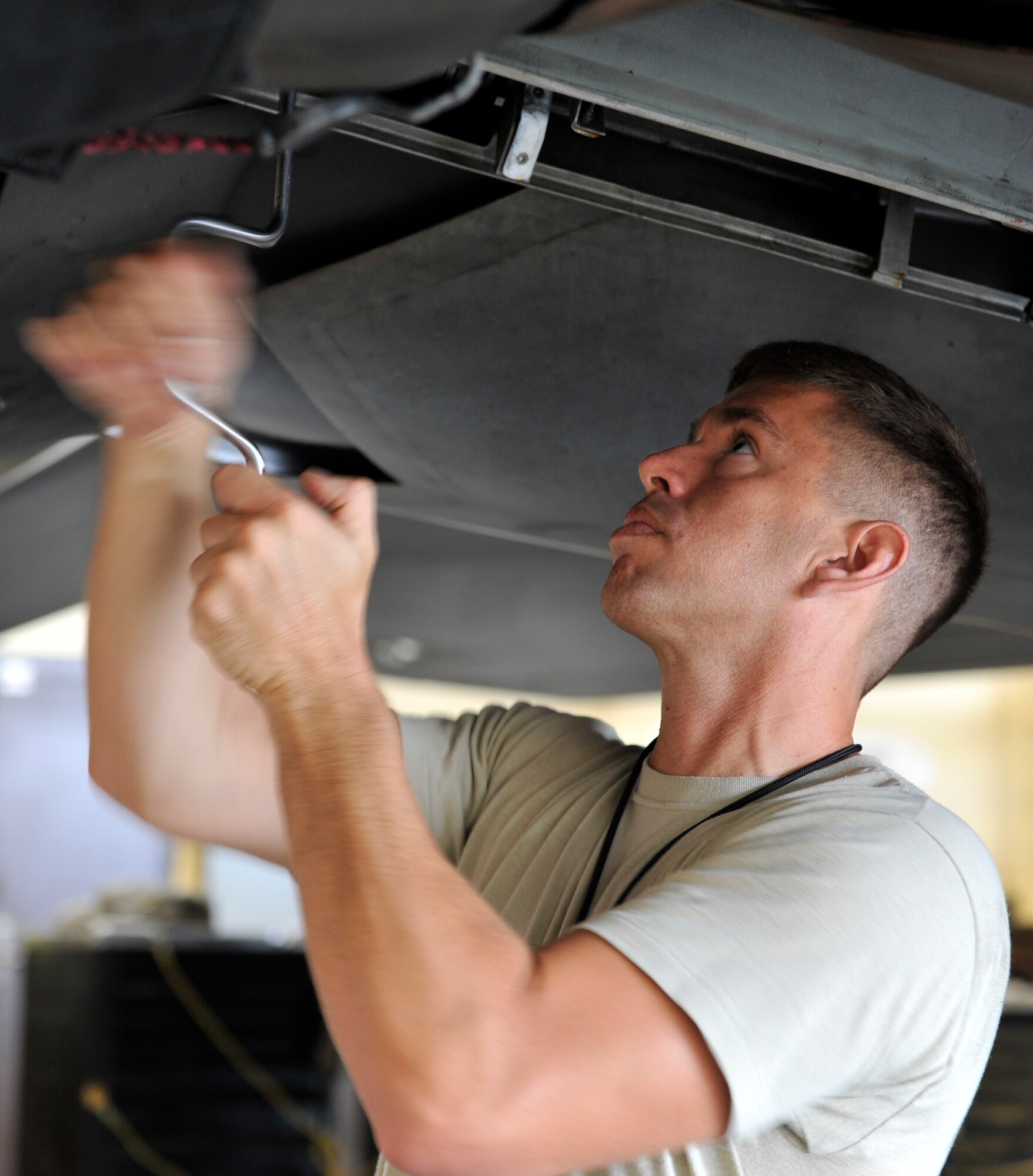 Staff Sgt. Derek Eubanks, 301st Aircraft Maintenance Unit F-22 Raptor dedicated crew chief, works on an F-22 June 5. Eubanks was chosen to be the Airman shadowed by the base commander for June as part of the Airman Shadow Program. (U.S. Air Force photo by Airman 1st Class Sergio A. Gamboa/Released)