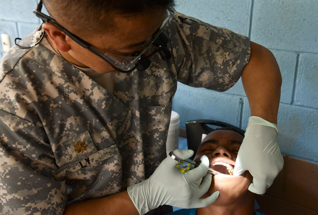 Maj. Blong Ly, a Medical Element doctor of dental surgery, administers a local anesthetic in preparation for pulling a patient’s tooth during a medical readiness training exercise June 2, 2015, at Corinto, Cortes, Honduras. The MEDRETE team performed dental work on more than 135 patients and educated them on proper dental hygiene. (U.S. Air Force photo by Staff Sgt. Jessica Condit)