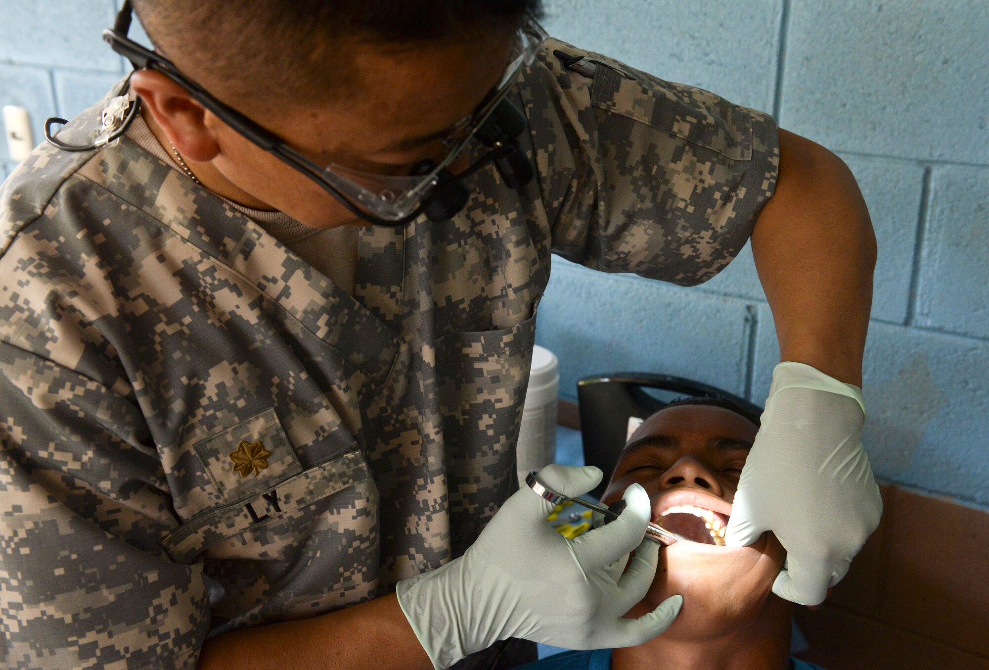 Maj. Blong Ly, a Medical Element doctor of dental surgery, administers a local anesthetic in preparation for pulling a patient’s tooth during a medical readiness training exercise June 2, 2015, at Corinto, Cortes, Honduras. The MEDRETE team performed dental work on more than 135 patients and educated them on proper dental hygiene. (U.S. Air Force photo by Staff Sgt. Jessica Condit)