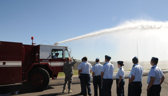 Royal Canadian Air Cadets file toward a fire engine of the 92nd Civil Engineer Squadron fire department at Fairchild Air Force Base, Wash., June 5, 2015. The cadets got to spray the fire hose as a demonstration of American military resources. (U.S. Air Force photo/Senior Airman Sam Fogleman)