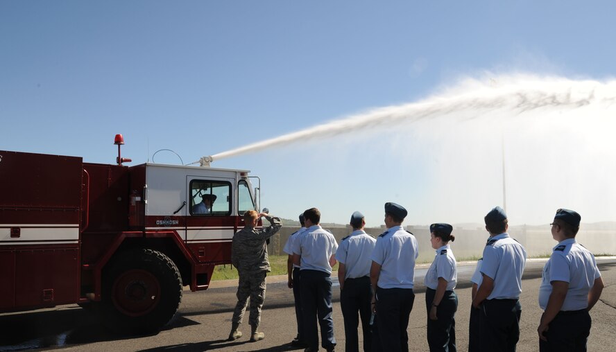 Royal Canadian Air Cadets file toward a fire engine of the 92nd Civil Engineer Squadron fire department at Fairchild Air Force Base, Wash., June 5, 2015. The cadets got to spray the fire hose as a demonstration of American military resources. (U.S. Air Force photo/Senior Airman Sam Fogleman)