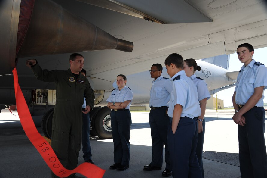 Senior Airman Greg Webb, 92nd Air Refueling Squadron boom operator, shows Royal Canadian Air Cadets a segment of the engine of a KC-135 Stratotanker at Fairchild Air Force Base, Wash., June 5, 2015. The tour of the aircraft was the lengthiest part of the tour. (U.S. Air Force photo/Senior Airman Sam Fogleman)