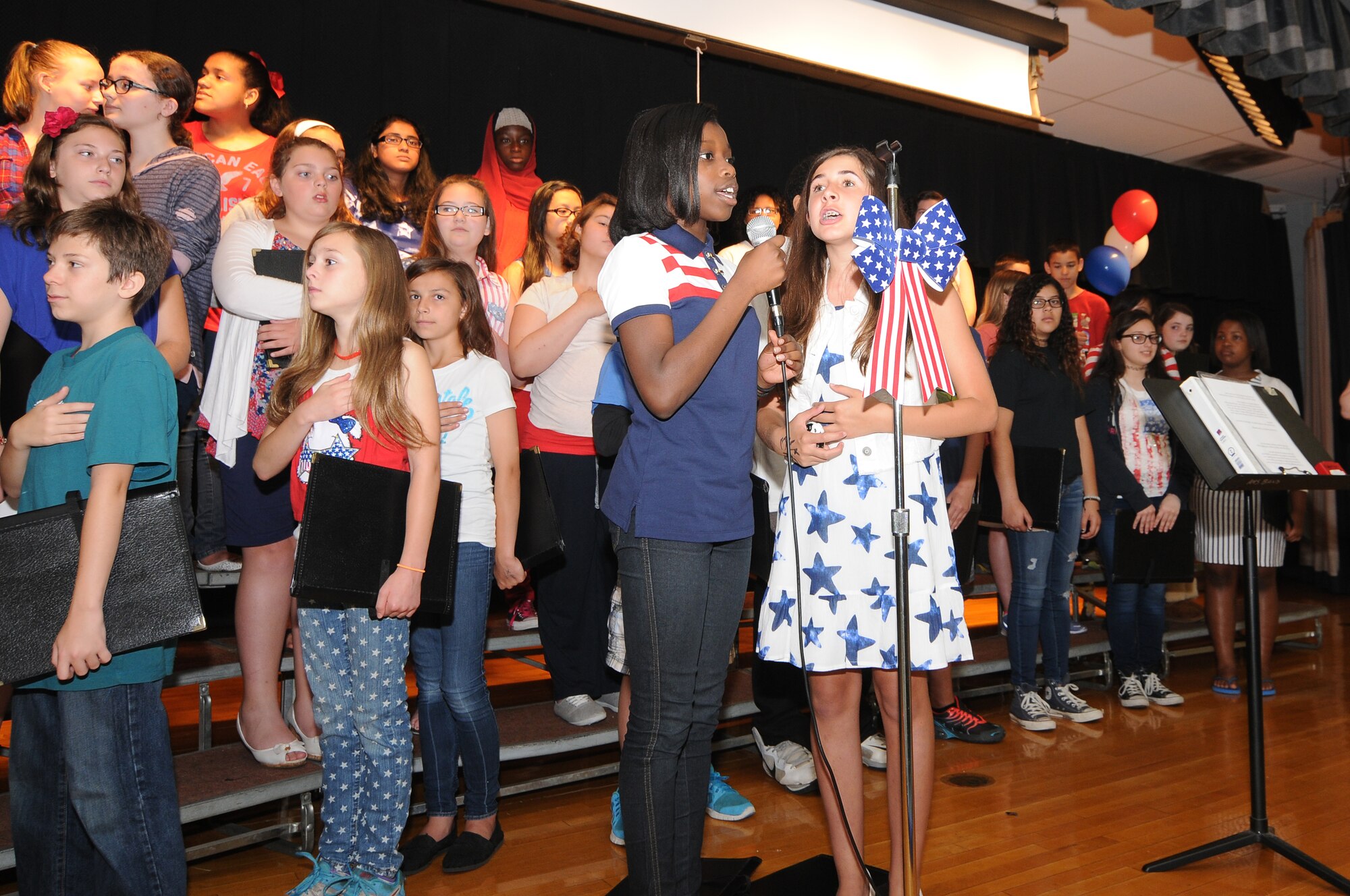 A picture of students singing the national anthem.