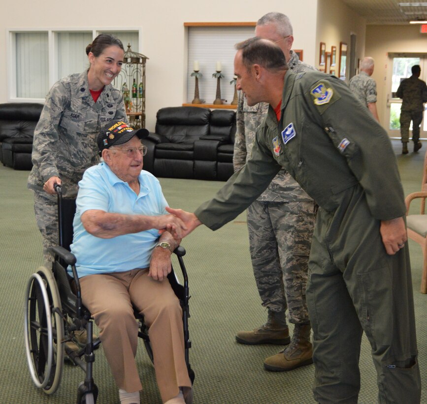 Maj. Gen. Trulan Eyre, Air National Guard Assistant to the Commander, 1st Air Force (Air Forces Northern), greets World War II veteran, Private First Class (Ret.) Ken Algar, at the 1st Air Force (Air Forces Northern) “Salute to Vets 2015” event at the Heritage Club, May 29, at  Tyndall Air Force Base. His military escort was Lt. Col. Kristin Ader, of the 1st AF (AFNORTH) Staff Judge Advocate General’s office. (Air Force Photo Released/Maj. Katrina Andrews)