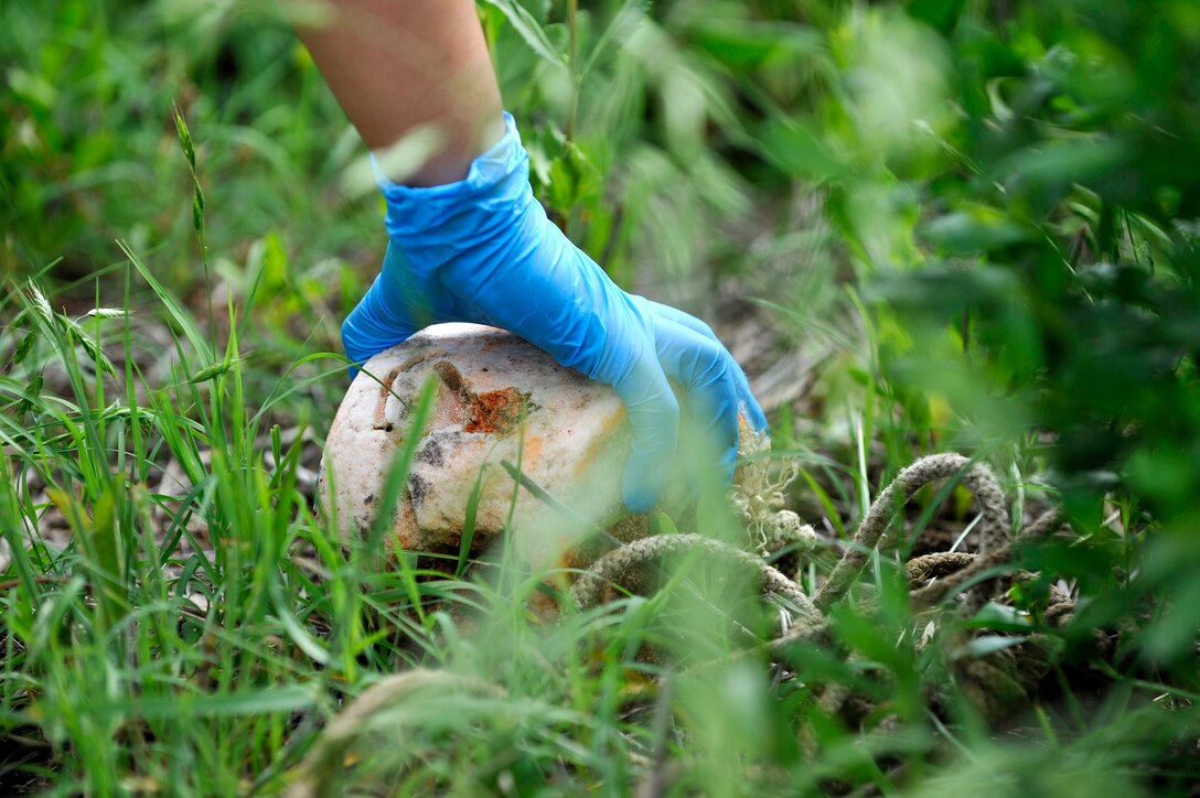 An U.S. Air Force Airman picks up trash during the 27th annual “Clean the Bay Day” at Langley Air Force Base, Va., June 6, 2015. Since 1989, “Clean the Bay Day” has engaged approximately 140,000 volunteers who have removed more than 6.2 million pounds of debris from more than 6,500 miles of shoreline. (U.S. Air Force photo by Senior Airman Breonna Veal/ Released)