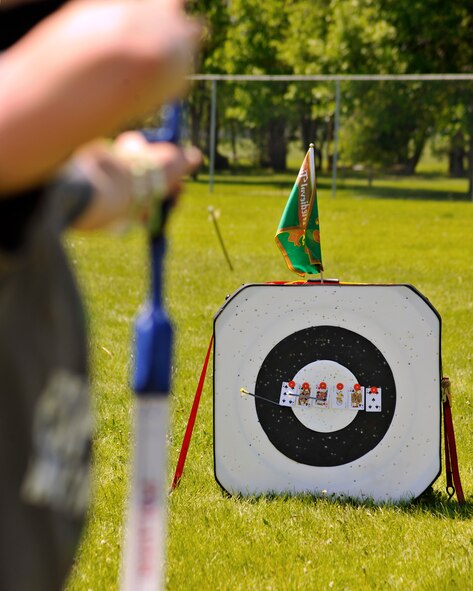 Archery students from the 319th Force Support Squadron Youth Center play a 21 card game during an archery camp June 9, 2015, on Grand Forks Air Force Base, N.D. The game consisted of hitting cards that had to equal up to a score of 21. The weeklong course is a two to three hour session which includes a wide variety of games and activities that challenges the shooter. (U.S. Air Force photo by Senior Airman Xavier Navarro/released)