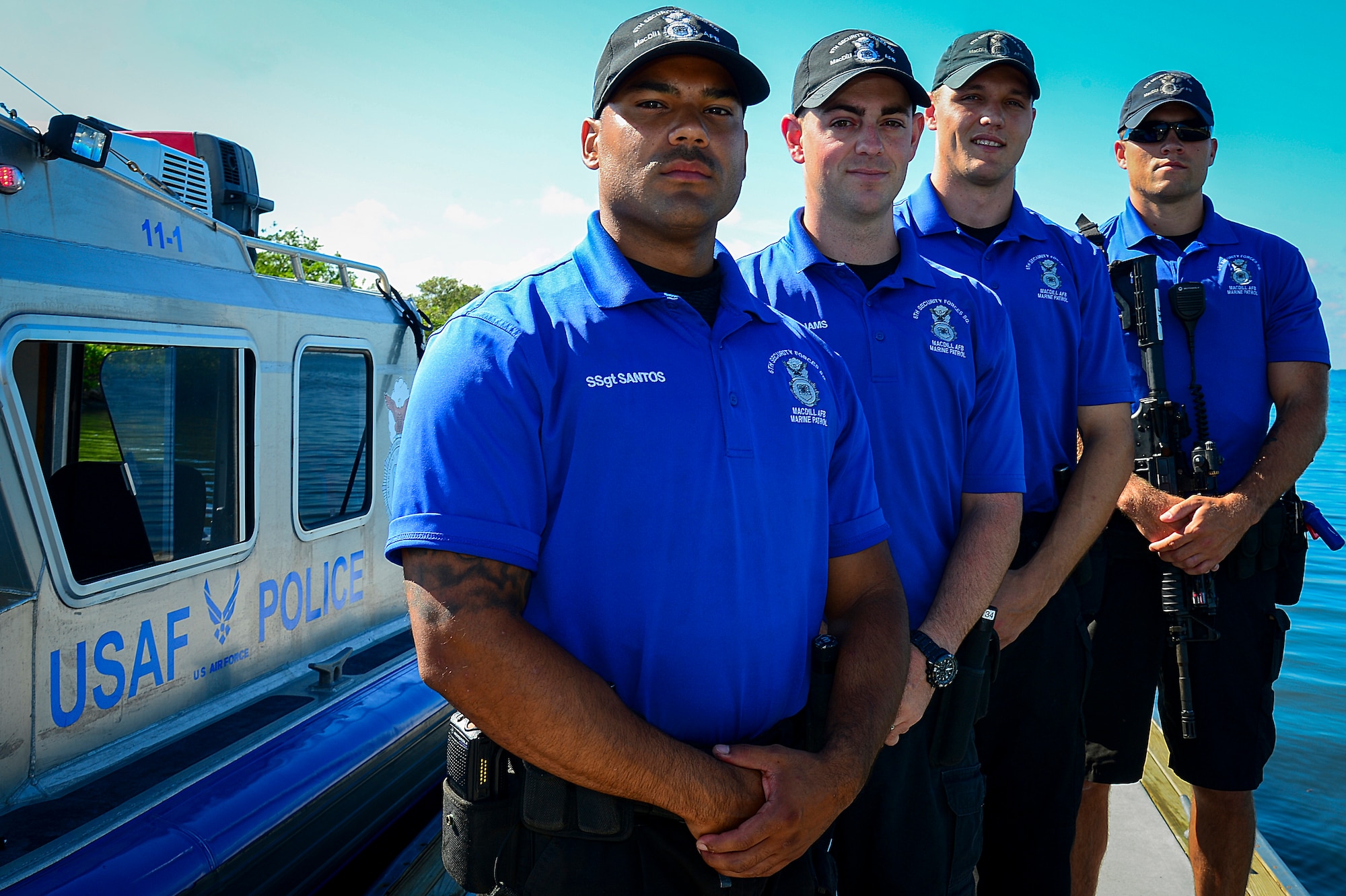 Marine patrolmen from the 6th Security Forces Squadron stand before a patrol boat just prior to launching the boat June 8, 2015, at MacDill Air Force Base, Fla. These four Airmen saved a woman from her suicidal drowning attempt at a boat ramp by the marina on MacDill. (U.S. Air Force photo by Senior Airman Ned T. Johnston/Released)