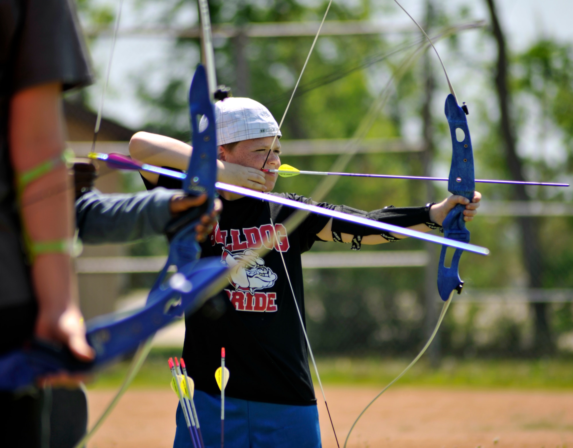 Jacob Warnke, 10, focuses his aim with a bow and arrow June 9, 2015, during an archery camp on Grand Forks Air Force Base, N.D. Archery camp teaches the fundamentals of archery safety and basic techniques. (U.S. Air Force photo by Senior Airman Xavier Navarro/released)