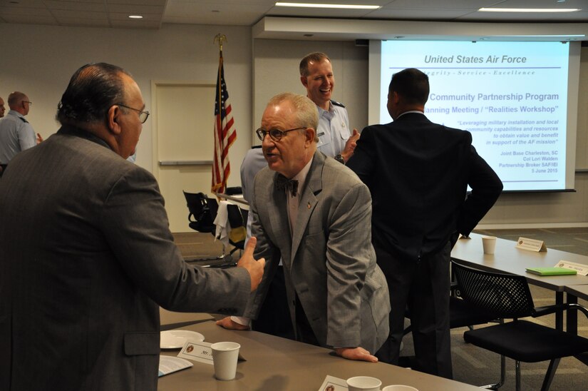 Jaime Ayala, 628th Force Support Squadron deputy, speaks with Peter Wertimer, president, Advertising Division at Chernoff Newman, LLC, during the P4 Community Partnering Final Planning Meeting June 5, 2015 at the Charleston Chamber of Commerce in North Charleston, S.C. Both base leadership and local community members have been working over the last several months in groups to look at and develop creative ways to leverage capabilities and resources, combine like services, and improve the quality of life for those who call Charleston home. The Final Planning Meeting, also called the “Realities Workshop,” was the third workshop held and provided a forum for the group to review ten potential initiatives and areas for partnership. (U.S. Air Force photo by Michaela Judge)