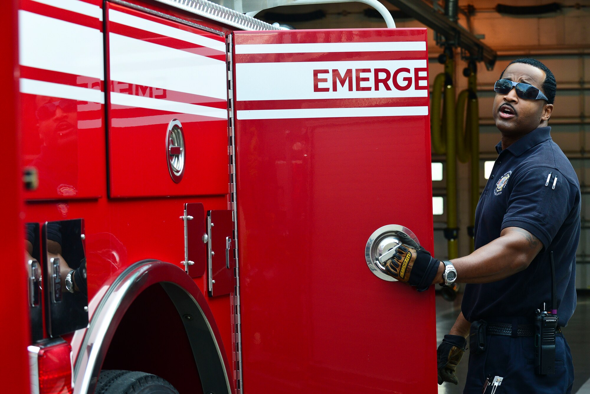 Phillip Hill, 733rd Civil Engineer Division Fire Department firefighter, inspects a fire truck at Fort Eustis, Va., June 8, 2015. The fire team inspects inside each compartment which hold a possible crucial item to saving a life or structure in an emergency. (U.S. Air Force photo by Senior Airman Kimberly Nagle/Released)   