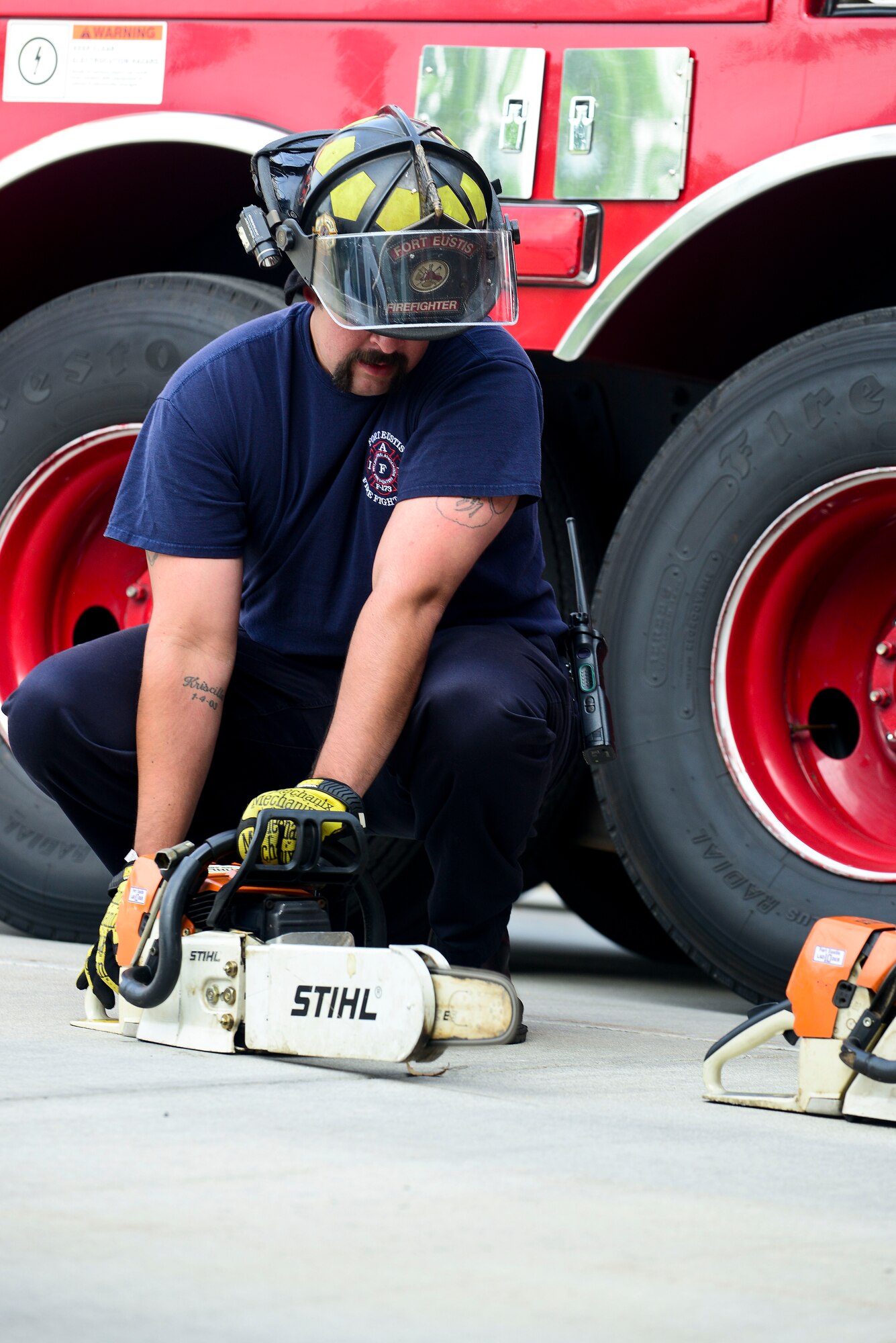 Alfonso Soto, 733rd Civil Engineer Division Fort Eustis Fire Department firefighter, inspects equipment at Fort Eustis, Va., June 8, 2015. The Fort Eustis fire trucks contain tools such as chainsaws, in case a power tool is needed in the event of an emergency, such as cutting a tree that has fallen in the road, or using the tools to extract a person from a vehicle. (U.S. Air Force photo by Senior Airman Kimberly Nagle/Released)  