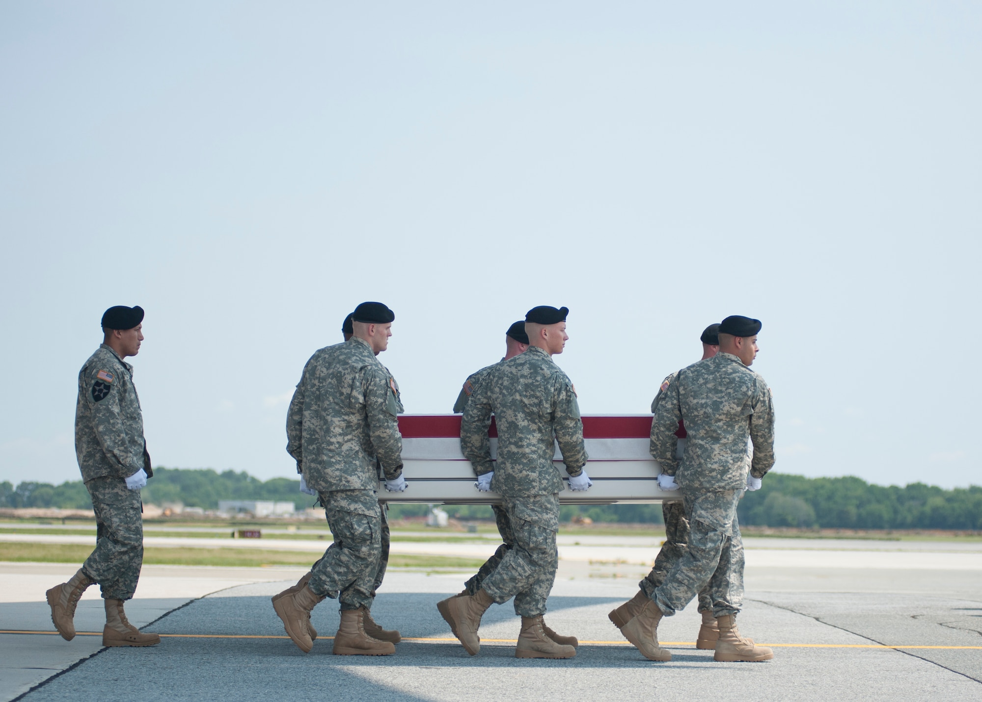 A U.S. Army carry team transfers the remains of Krissie K. Davis of Talladega, Ala., during a dignified transfer June 10, 2015, at Dover Air Force Base, Del. Davis was a member of the Defense Logistics Agency at Anniston, Ala., and deployed to DLA Disposition Services Bagram Airbase, Afghanistan, as part of the civilian expeditionary workforce. (U.S. Air Force photo/Senior Airman Jared Duhon) 